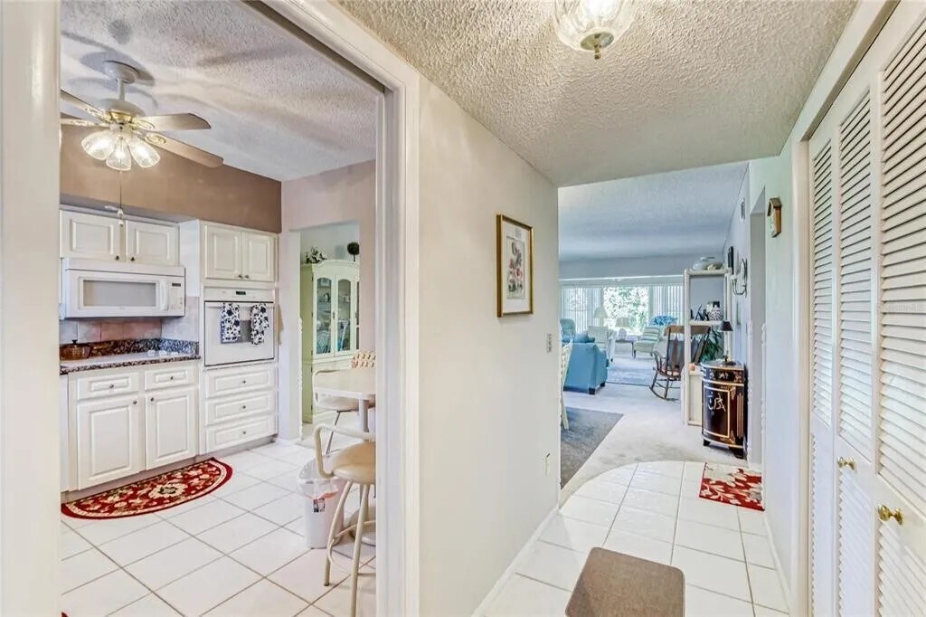 Entry Hallway. Dining area with side window view of golf course. [Unit is unfurnished] - 2460 Franciscan Dr