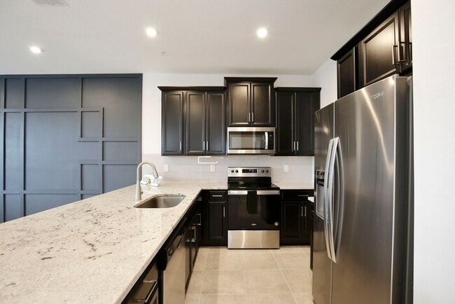 Building Photo - Luxurious 3/2.5 Modern Townhome with a Private Balcony and a 2 Car Garage in the Exclusive Gated ...