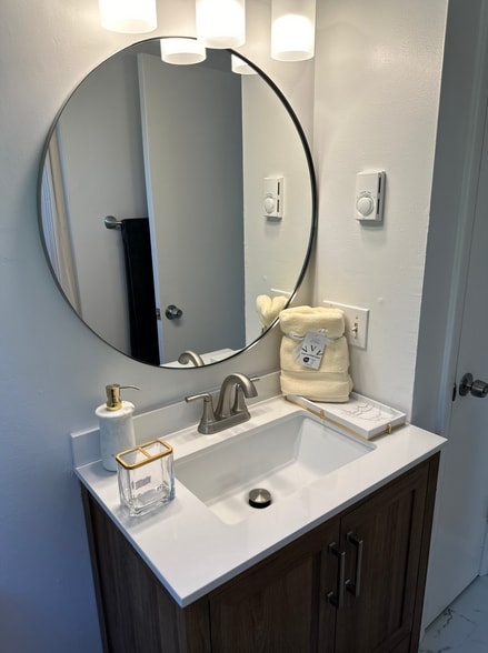 Bathroom with new vanity, mirror & lighting - 91 Faith St