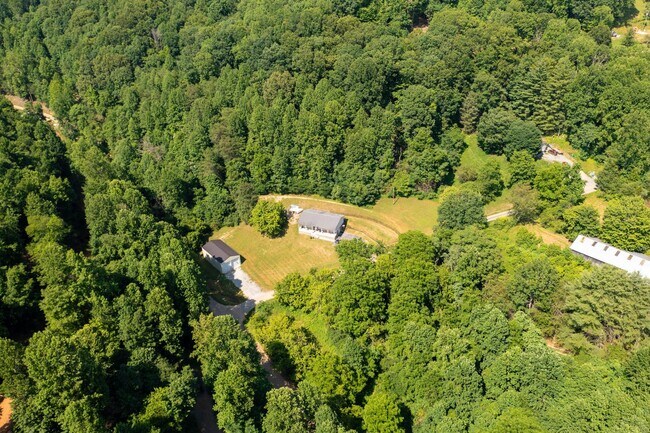 Building Photo - 3 br/ 2 bath home, private setting with garage/workshop