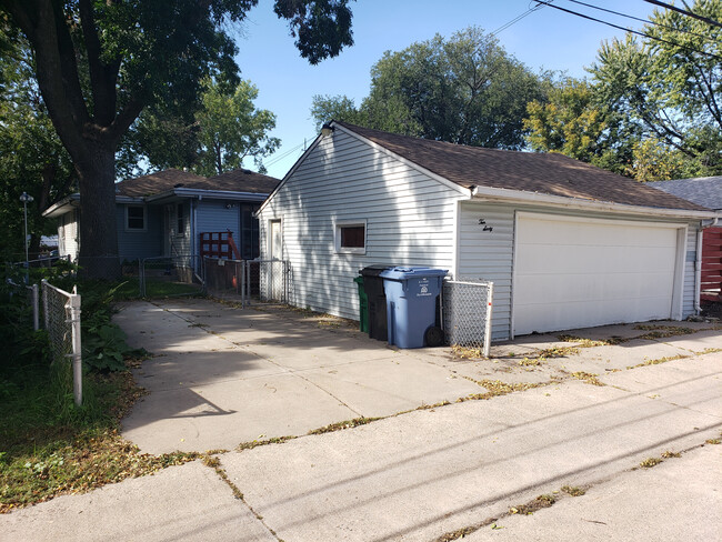 Large two-car garage with parking spot on the side. - 1060 21st Ave SE