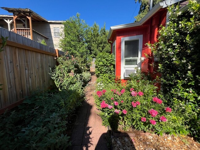 Building Photo - Charming Red Cottage with Lush Garden Spac...