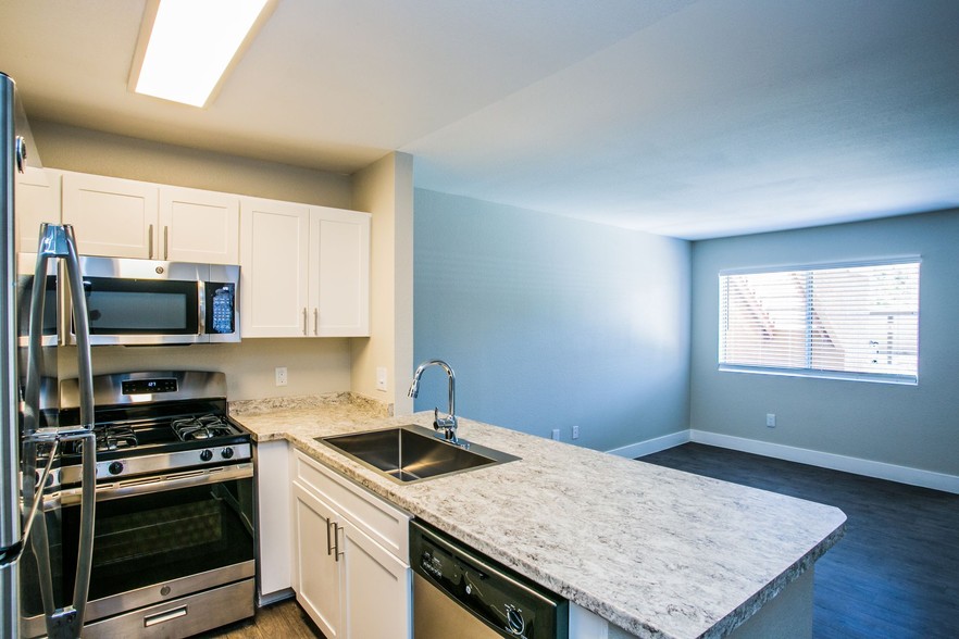 Kitchen breakfast bar overlooking apartment living area. - The Lido Apartments