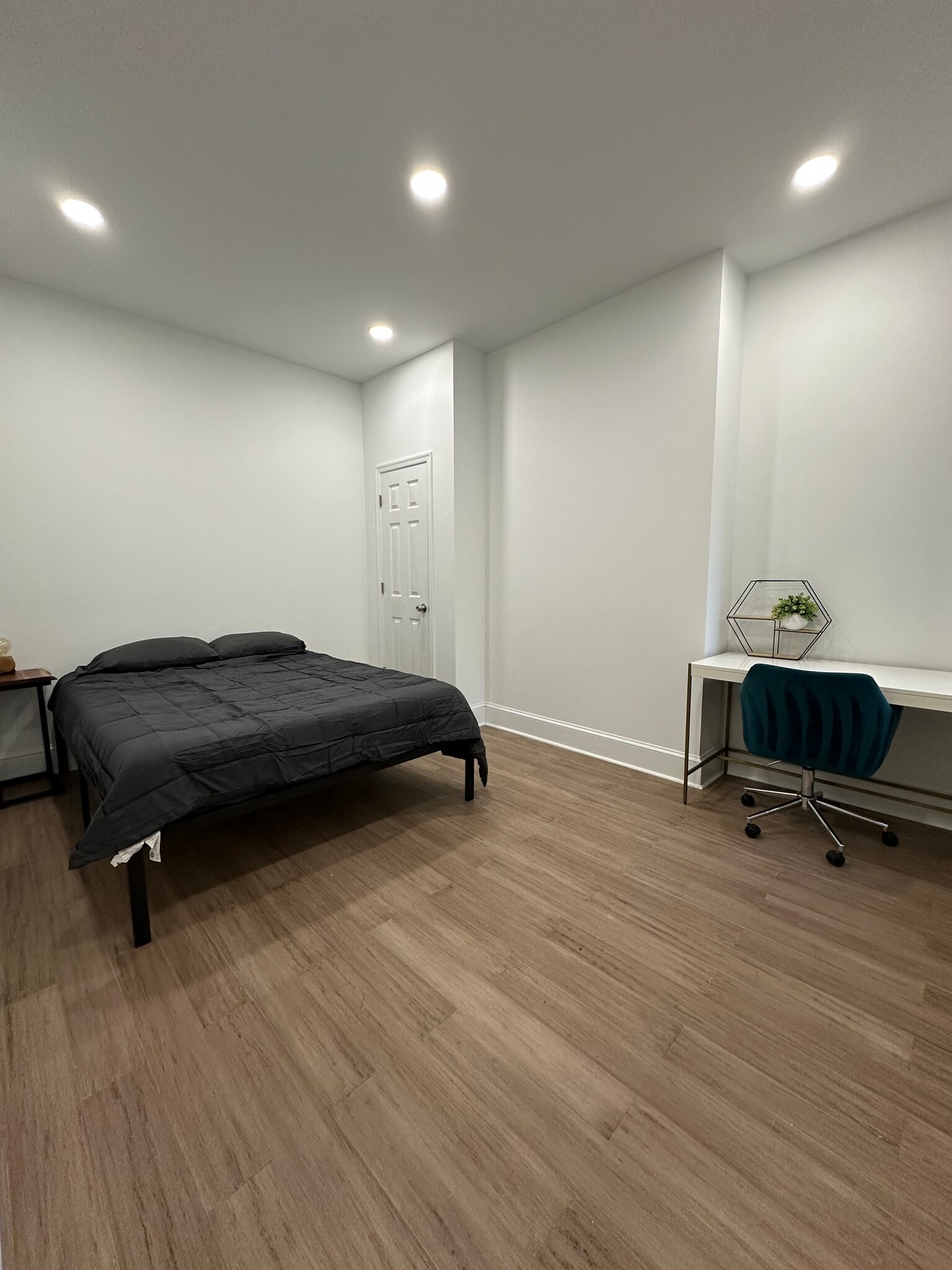 1st bedroom with queen size bed, a desk and a chair. Small closet next to bed. - 313 N 37th St