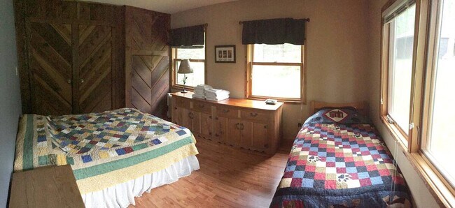 The bedroom has been updated with white walls that better highlight the custom cedar built-in closet - 6012 Highway 61