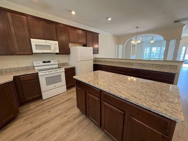 Building Photo - Beautifully updated Townhome! New cabinets, granite counter tops, and LVP flooring through downst...