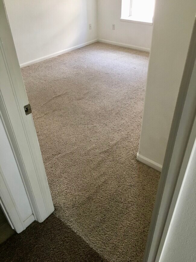 Primary bedroom before carpet was stretched - 1208 Walnut Ave