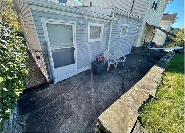 The rear patio offers pleasant outdoor space with walk out basement and water hookup - 212 Lorenz Ave