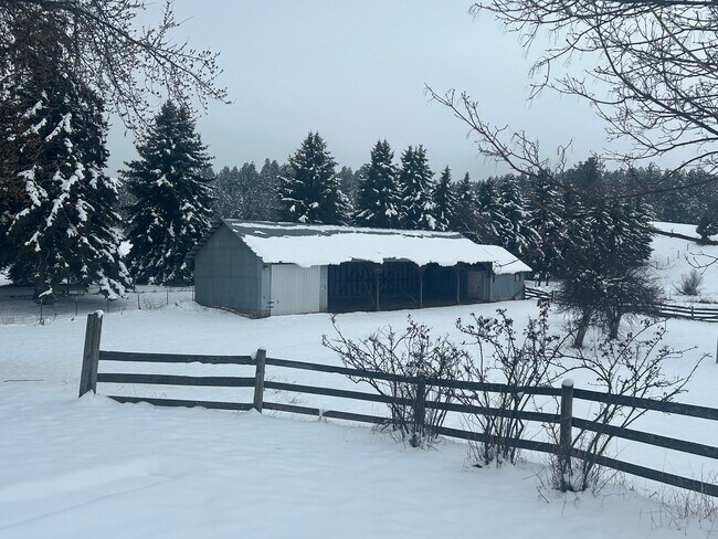 Building Photo - Bigfork Rodeo Farmhouse~ Fenced garden, greenhouse, garage, barn and shop!