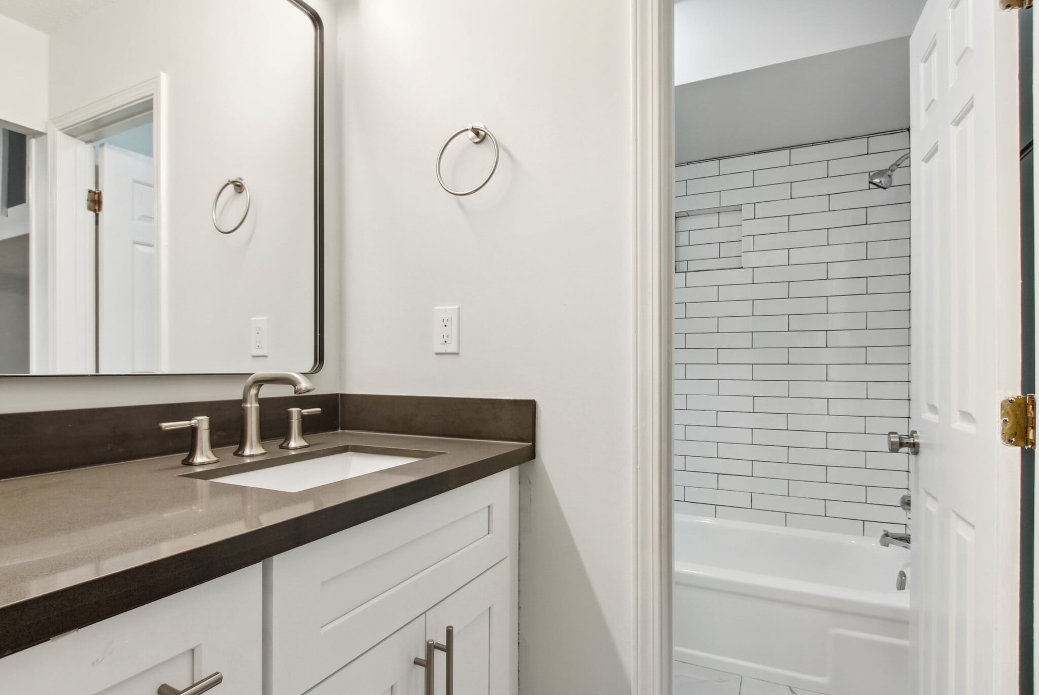 Front bedroom bathroom looking in to brand new bathtub with tiled walls. - 4502 Park Dr N