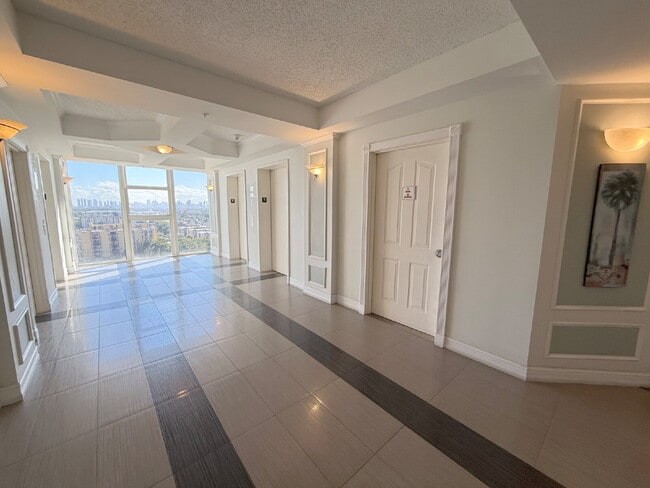 Building Photo - Rare 2/2 Corner Penthouse with Panoramic Lagoon Views from Every Room – Available Now!