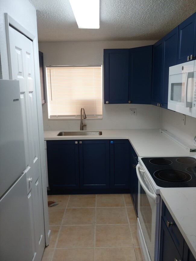 Kitchen from living room entrance - 6130 W 21st Ct