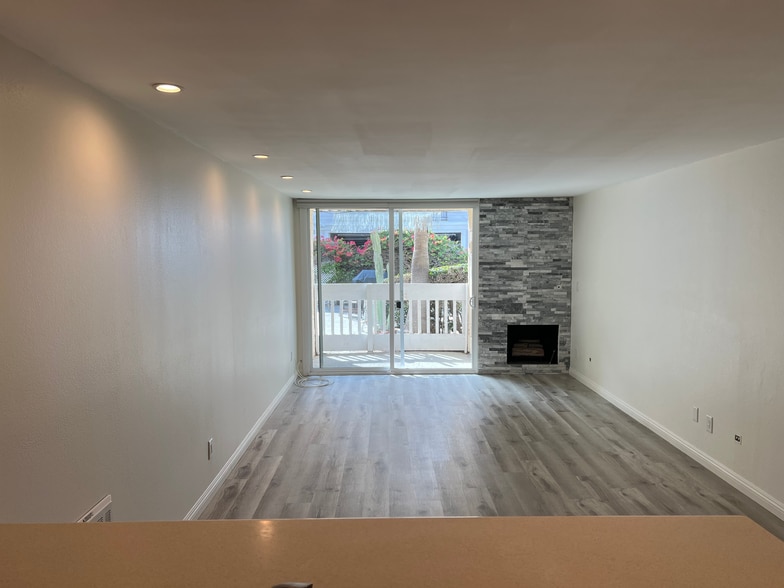 Functional main living space with stone ledger gas fireplace - 22 Navy St