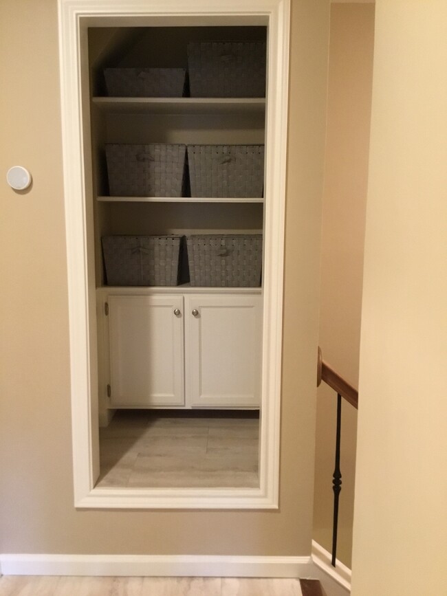 Open storage and cabinet storage at upstairs hall - 1103 Dulles Ave