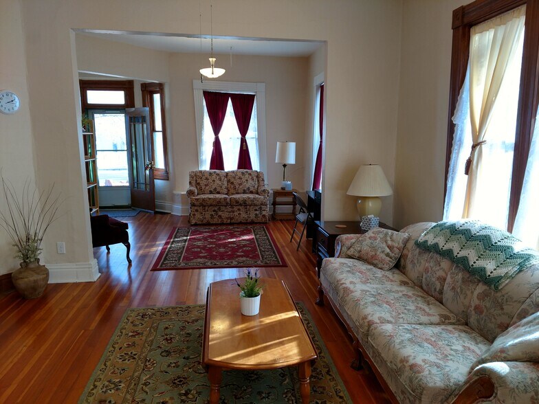 View of front and middle living rooms (furnishings not included with rental) - 607 Harrison Ave