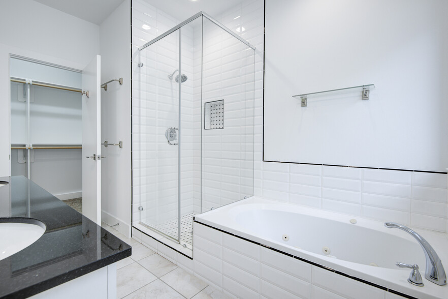 Another view of walk-in shower and jacuzzi style tub. - 4202 Spencer St