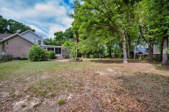 Building Photo - Spacious 3BR Retreat with Soaring Ceilings & Screened Porch
