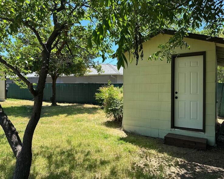 Backyard shed with built-in shelves—perfect for extra storage or workspace. - 4570 58th St