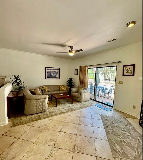 Living room opens onto patio. - 10027 Washington Cir