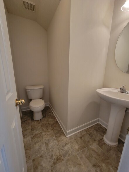 Downstairs powder room provides convenience for guests. - 6903 Seney Dr