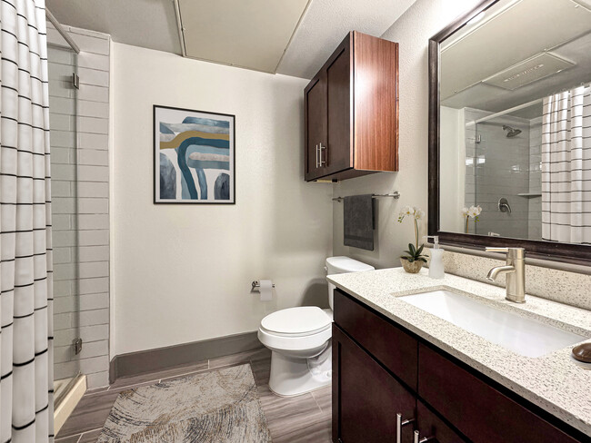 Experience elegance in every detail of this modern apartment bathroom. - Midtown Houston Living