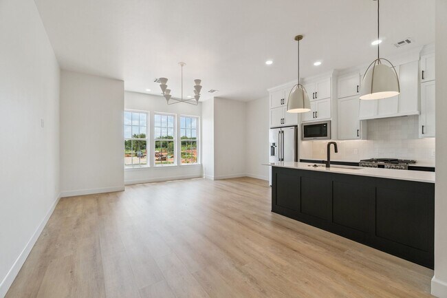 Building Photo - Bright. Clean. Calm. Your Elevated One-Bed...