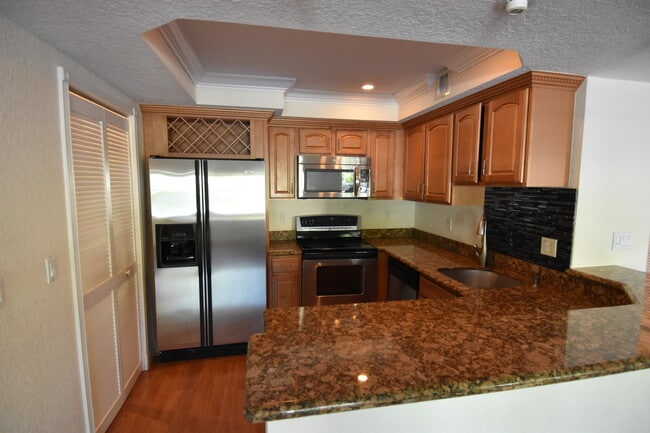 Kitchen with granite bar - 150 NE 15th Ave