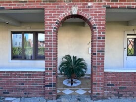 brick arch entry to home with covered porch - 239 Kingston Ave
