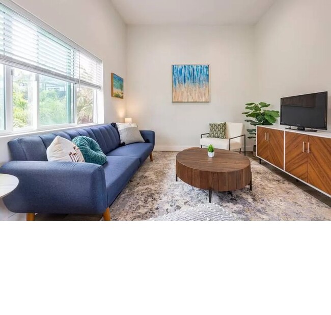 The 10 foot ceilings make this living space feel larger and airy. - 3355 Lloyd St