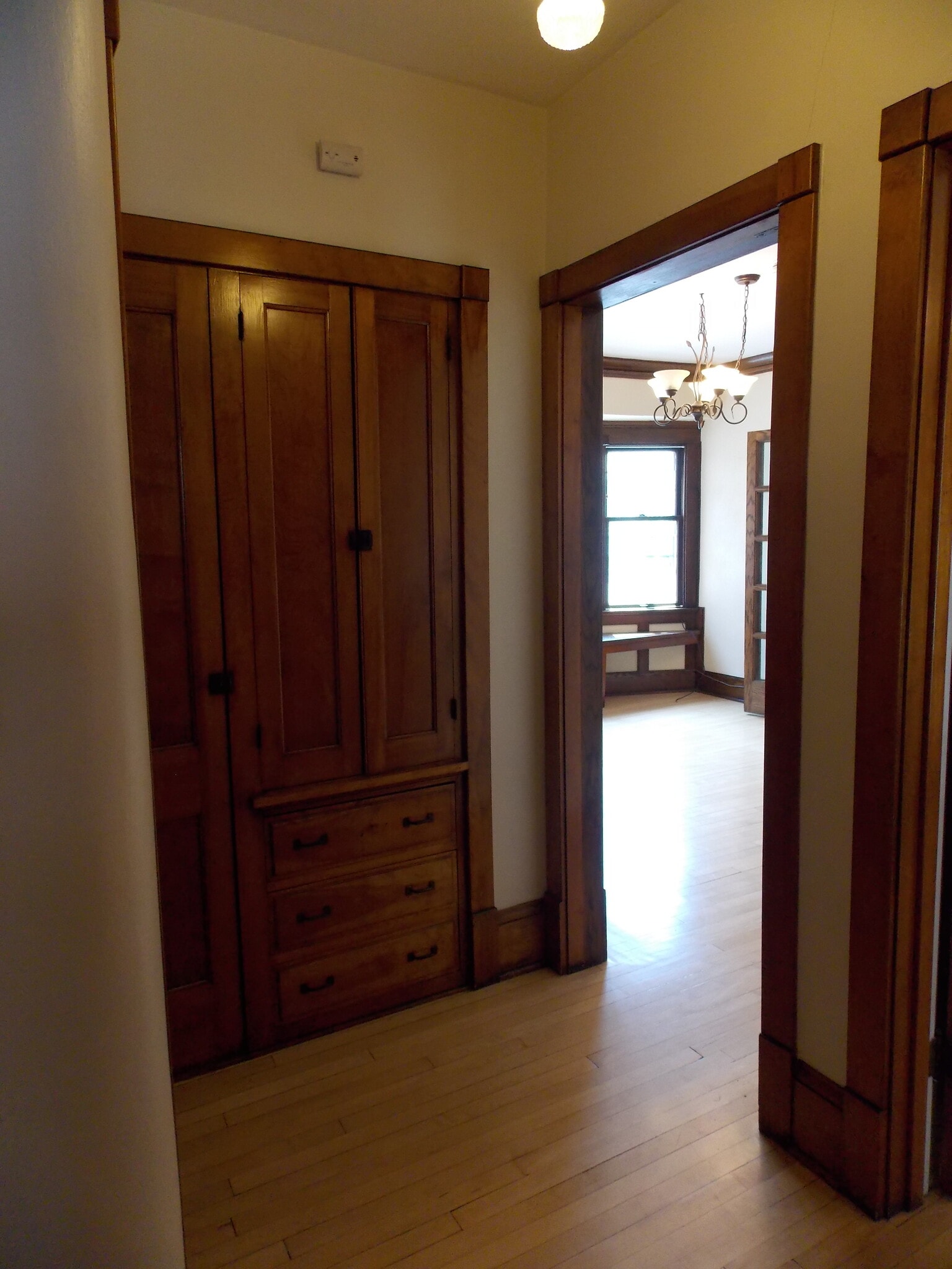hall with built in armoire, broom closet and linen closet - 3408 N Downer Ave