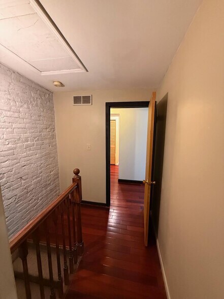 High ceilings and wood flooring throughout make the space feel large and open - 327 Hudson Ave