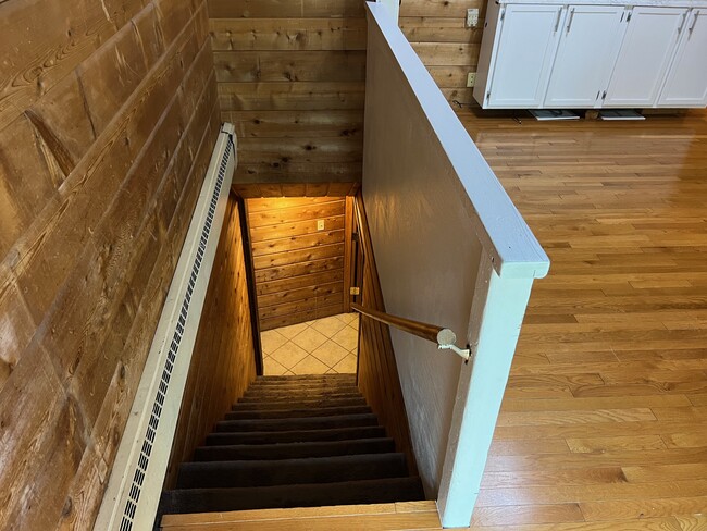 Staircase from kitchen to basement. Sliding glass back entry is at top of stairs. - 1120 Lealand Rd E
