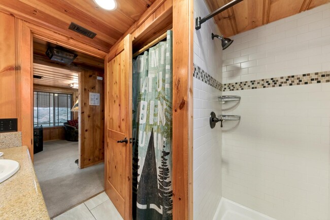 Bathroom with walk in shower and stacked washer dryer - 1139 Craig Ave