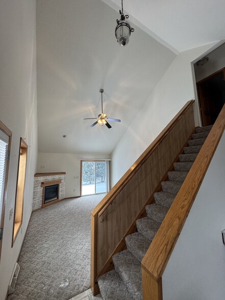 Living room with stair case up to 2nd floor kitchen behind photo - 628 E Pine St