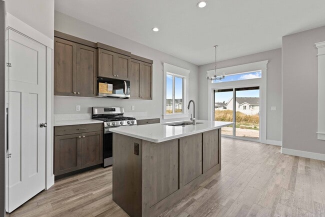 Building Photo - NEW HOME with large garage stalls and unfinished basement for additional storage