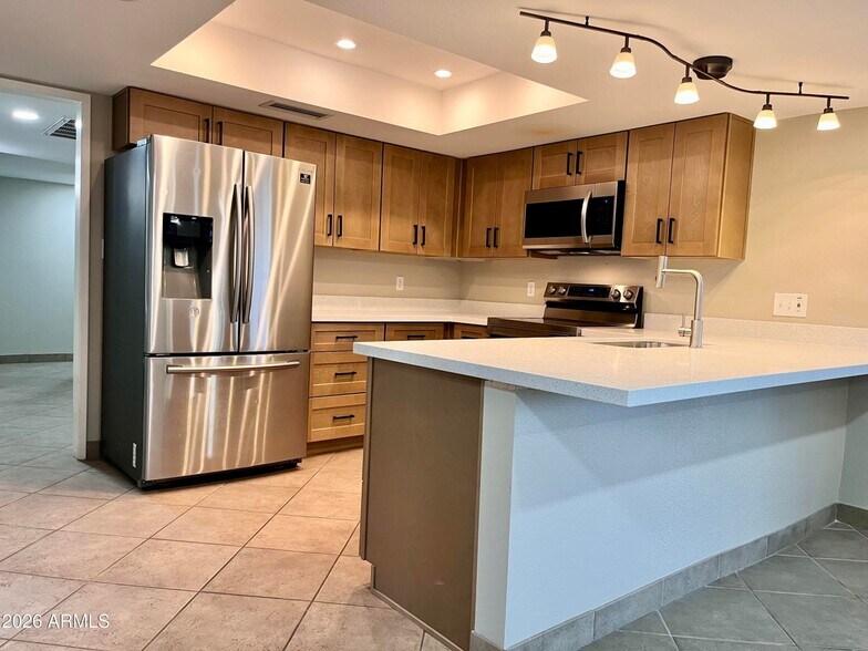 Updated lighting, cabinets, counter - 11625 S Mohave St