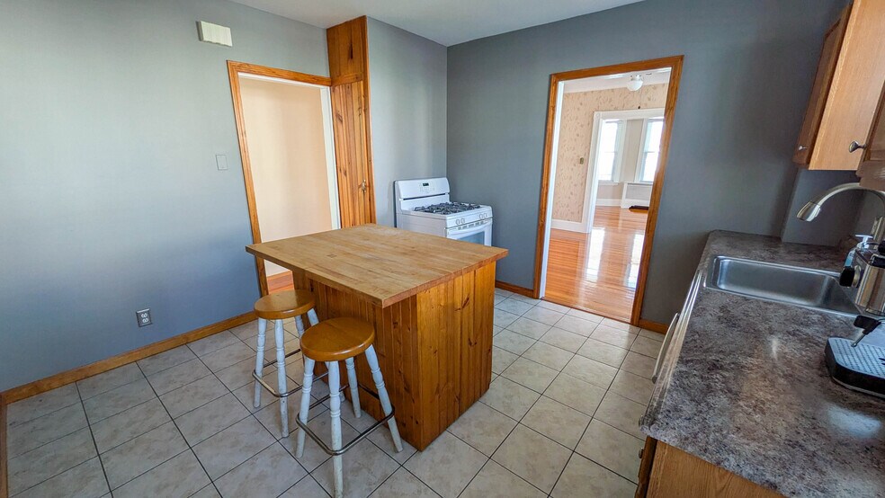 Kitchen with butcher block island, gas cooking and rare walk-in pantry offering excellent storage - 37 Glover Ave