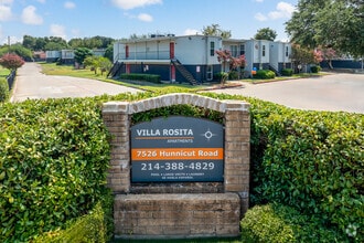 Villa Rosita Entrance Drive – Gated community entry with monument sign and manicured greenery. - Villa Rosita Apartments