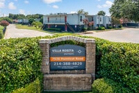 Villa Rosita Entrance Drive – Gated community entry with monument sign and manicured greenery. - Villa Rosita Apartments