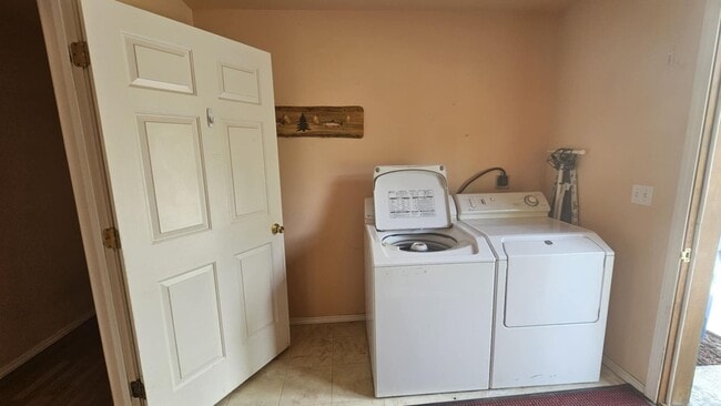 Building Photo - Out of town house with double garage and l...