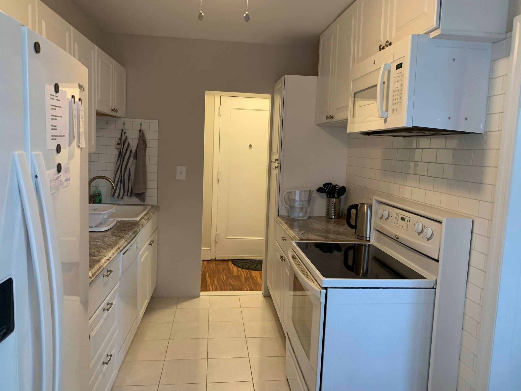 Kitchen has double door fridge, over the range microwave, electric stove, dishwasher & garbage disp. - 160 72nd St