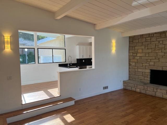 Living room with wood-burning, gas-assisted fireplace, breakfast nook, and kitchen - 2812 Anchor Ave