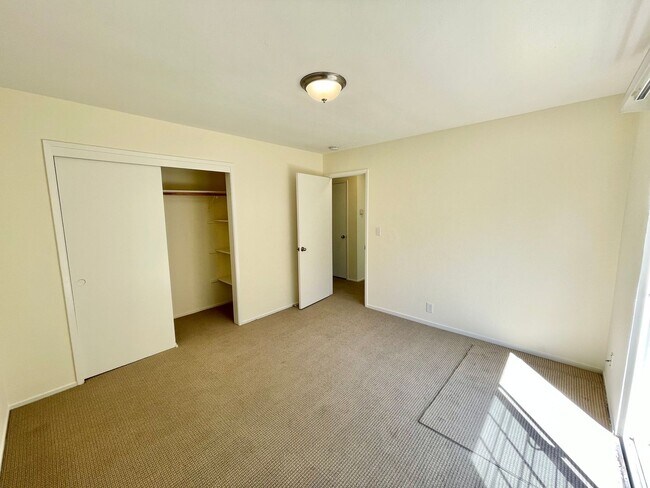 Building Photo - Sunlit 2BD/1BA w/ Private Balcony + Backyard! New Carpet! Assigned Parking! PROGRESSIVE