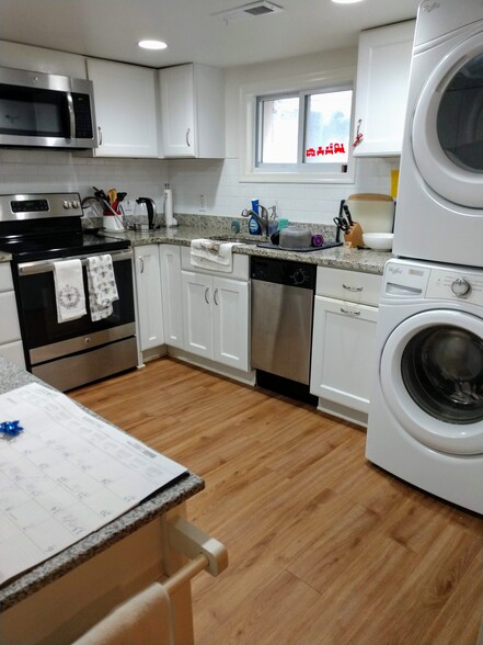 Kitchen with full-sized washer/dryer. Kitchen has storage closet, disposal, disherwasher. - 2509 10th St NE