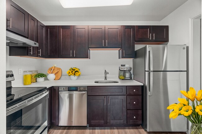 Step into a stylish kitchen that perfectly blends elegance with functionality. - University Crossing Apartments