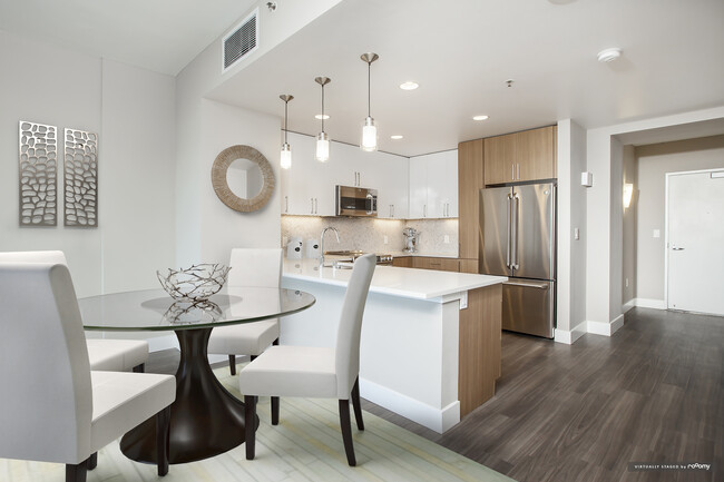 Signature Collection Dining and Kitchen Area with Hard Surface Vinyl Plank Flooring - Avalon Towers on the Peninsula