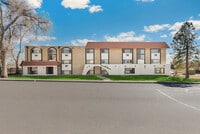 Charming apartment building with modern architecture, featuring large windows and scenic views. - Country Club