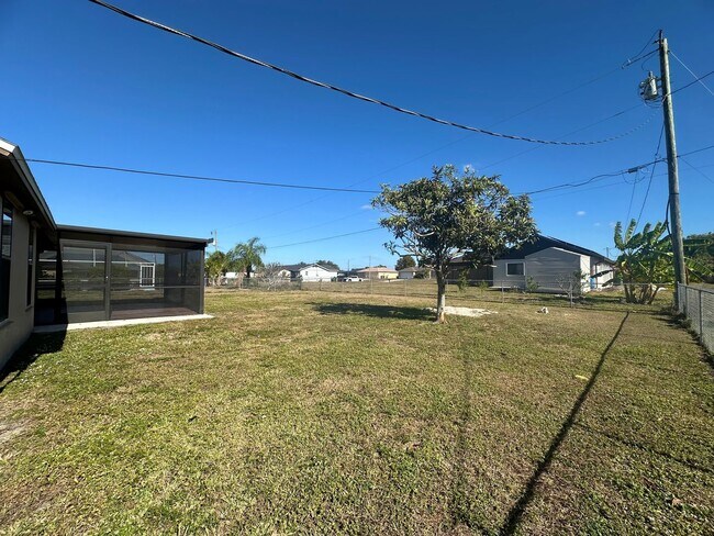Building Photo - Fenced 3/2 with Screened Lanai in NE Cape Coral