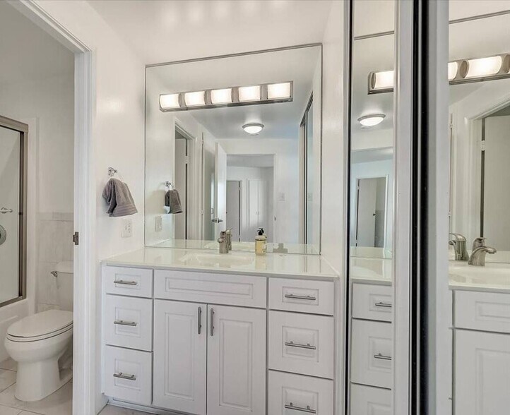 Master bathroom displays an extra mirror closet for more storage space - 700 E Ocean Blvd