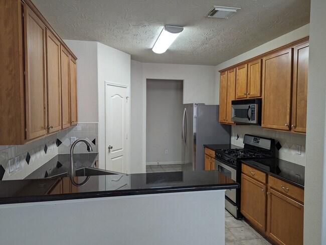 Kitchen includes large cabinets with upgraded cabinet knobs for easy opening. - 5910 Hollister Cole